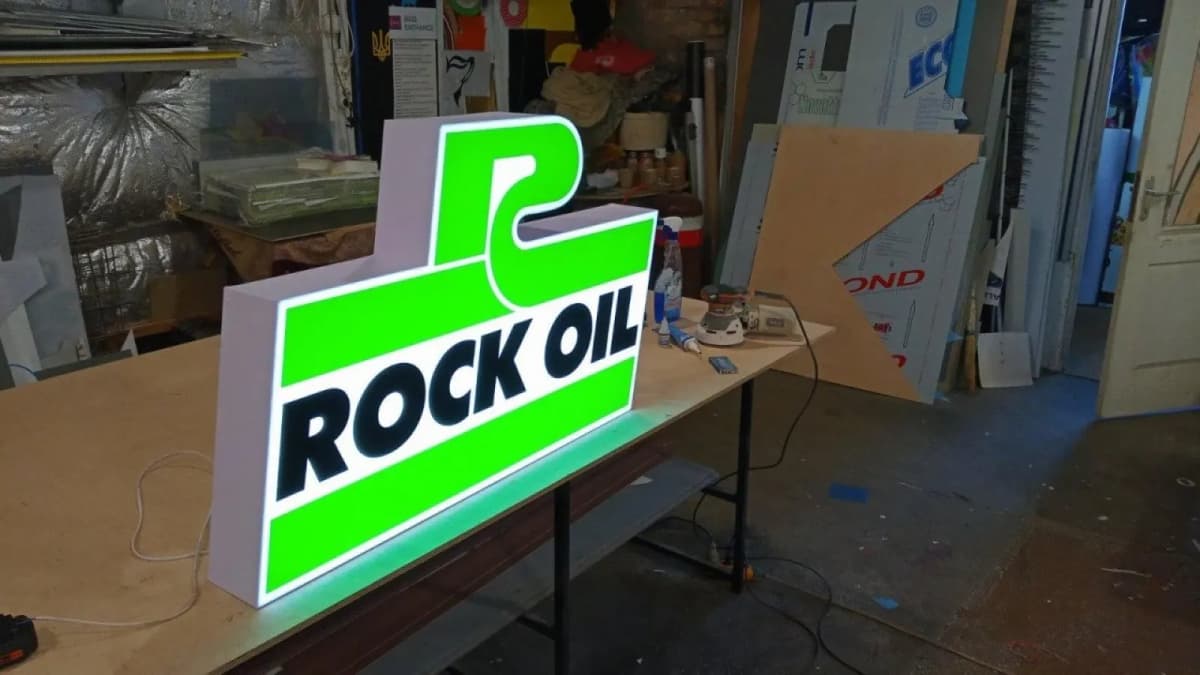 Shaped Rock Oil lightbox switched on in the workshop before installation