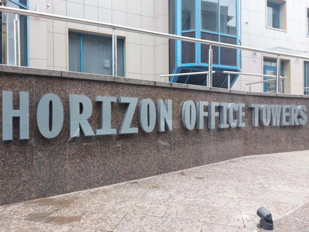 3D metal HORIZON OFFICE TOWERS letters on a polished granite wall