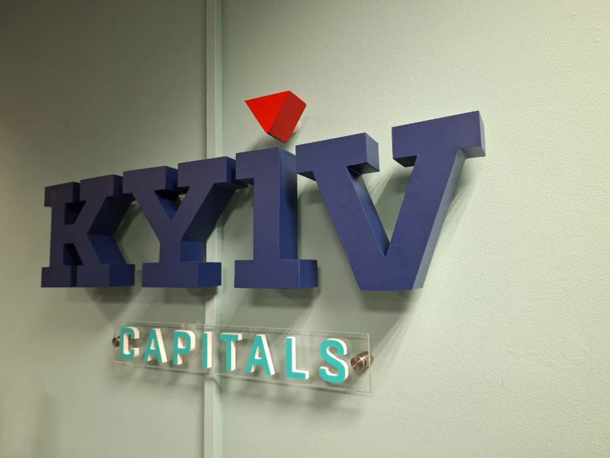Blue dimensional KYIV letters with a red pyramid above them and a clear CAPITALS plate on standoffs