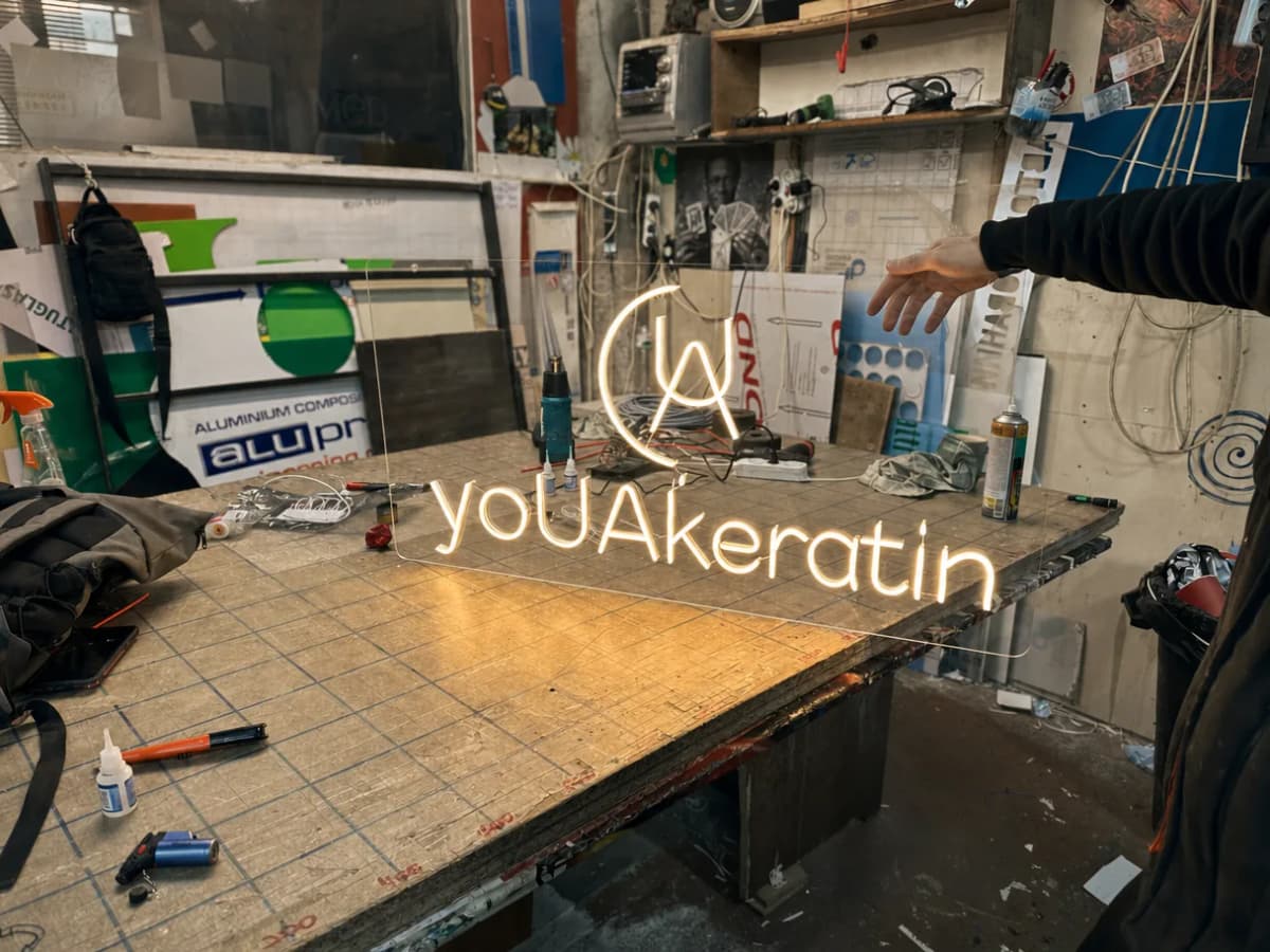 A finished neon sign lit up on the workbench of TheFace’s own workshop in Kyiv